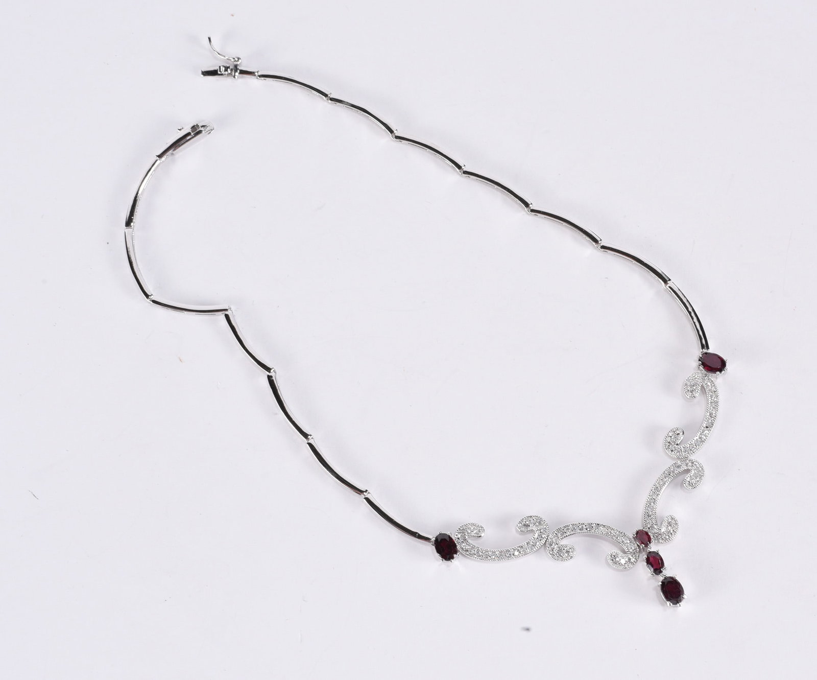 Sterling Silver articulated necklace w/ garnets and white stones. Marked FAS & 925. 16" - 18.5: Sterling Silver articulated necklace w/ garnets and white stones. Marked FAS & 925. 16" - 18.5 grams