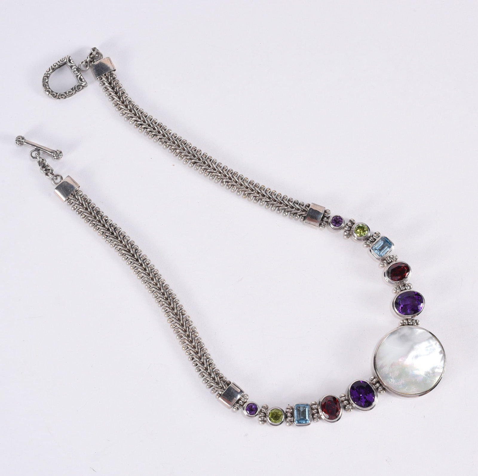 Sterling Silver and gemstone necklace with MOP center. Medallion marked 925. 16" - 79.8 grams: Sterling Silver and gemstone necklace with MOP center. Medallion marked 925. 16" - 79.8 grams