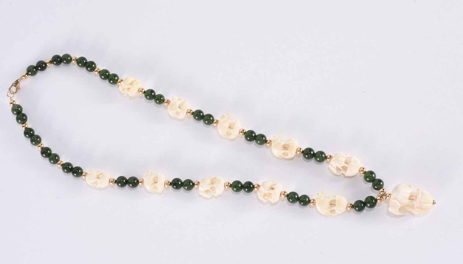 Carved bone elephant necklace and clip earrings, with Gold Fill findings. Green and gold tone (1 of 2)