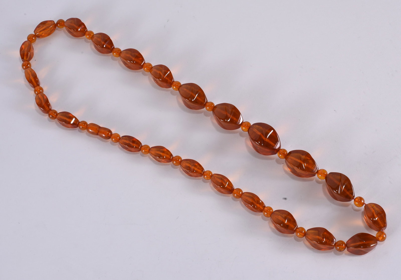 Vintage screw closure amber necklace, graduated faceted oval beads with round bead spacers. 26": Vintage screw closure amber necklace, graduated faceted oval beads with round bead spacers. 26"