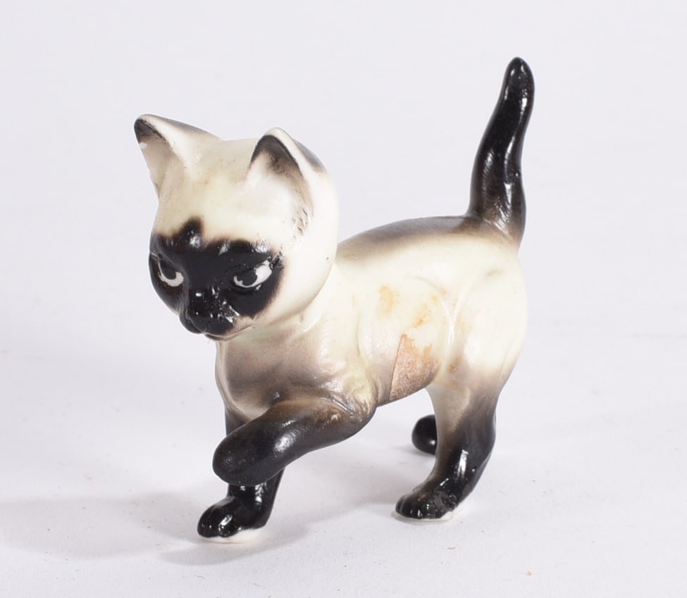 Siamese Cat Ceramic Figurine: Glazed ceramic Siamese cat figurine with dark facial mask and paws, modeled in walking pose.