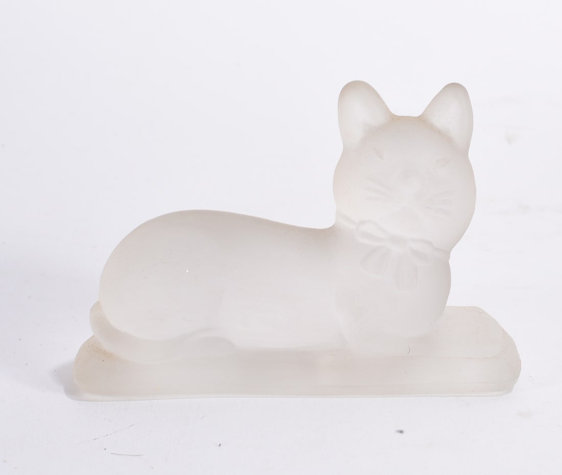Frosted Glass Cat Figurine: Frosted white glass cat figurine in reclining pose with molded ribbon decoration and matte finish.