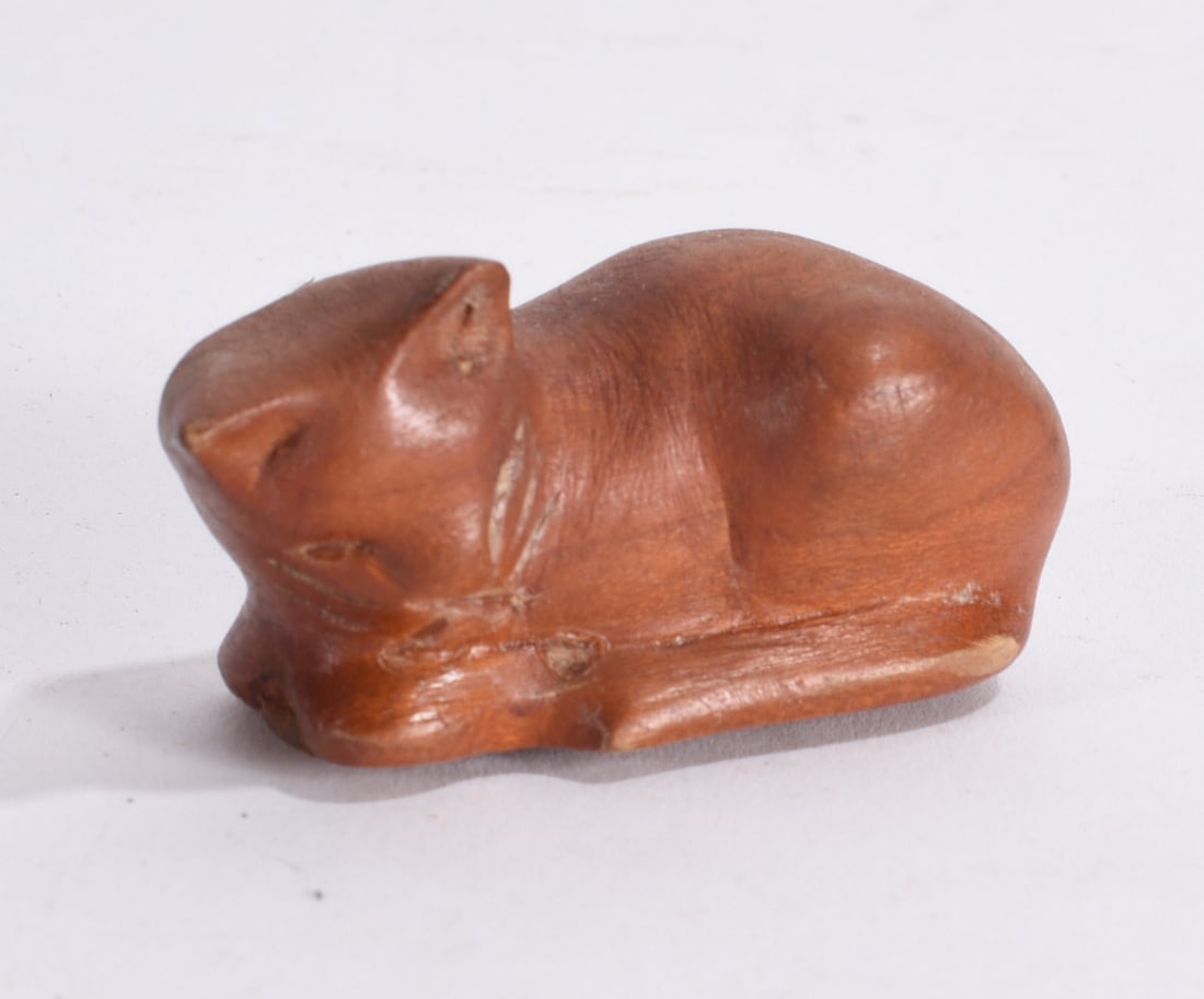 Carved Wooden Sleeping Cat Figure: Hand carved wooden cat figurine in sleeping pose with warm brown finish and incised detail.