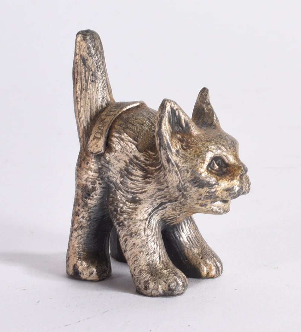 Cast Metal Cat Miniature: Small cast metal cat miniature in arched pose with textured fur detail and aged finish.