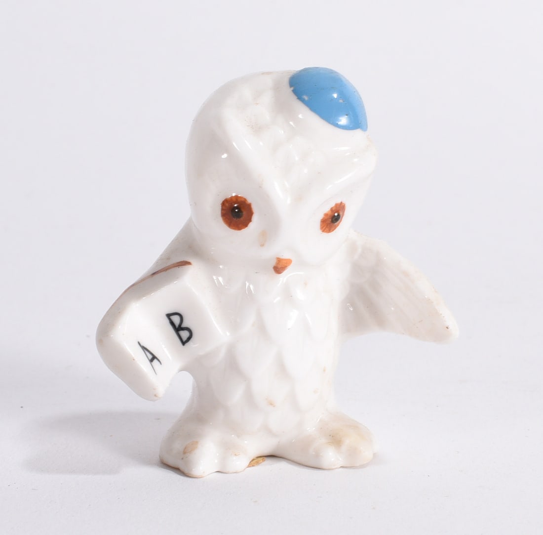 Ceramic Owl Teacher Figurine: Whimsical white ceramic owl figurine holding an ?A B? school book with blue cap decoration.