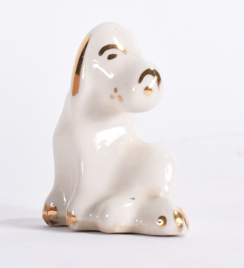 White Dog Figurine with Gold Trim: White ceramic rabbit figurine with gold accent decoration and seated pose.