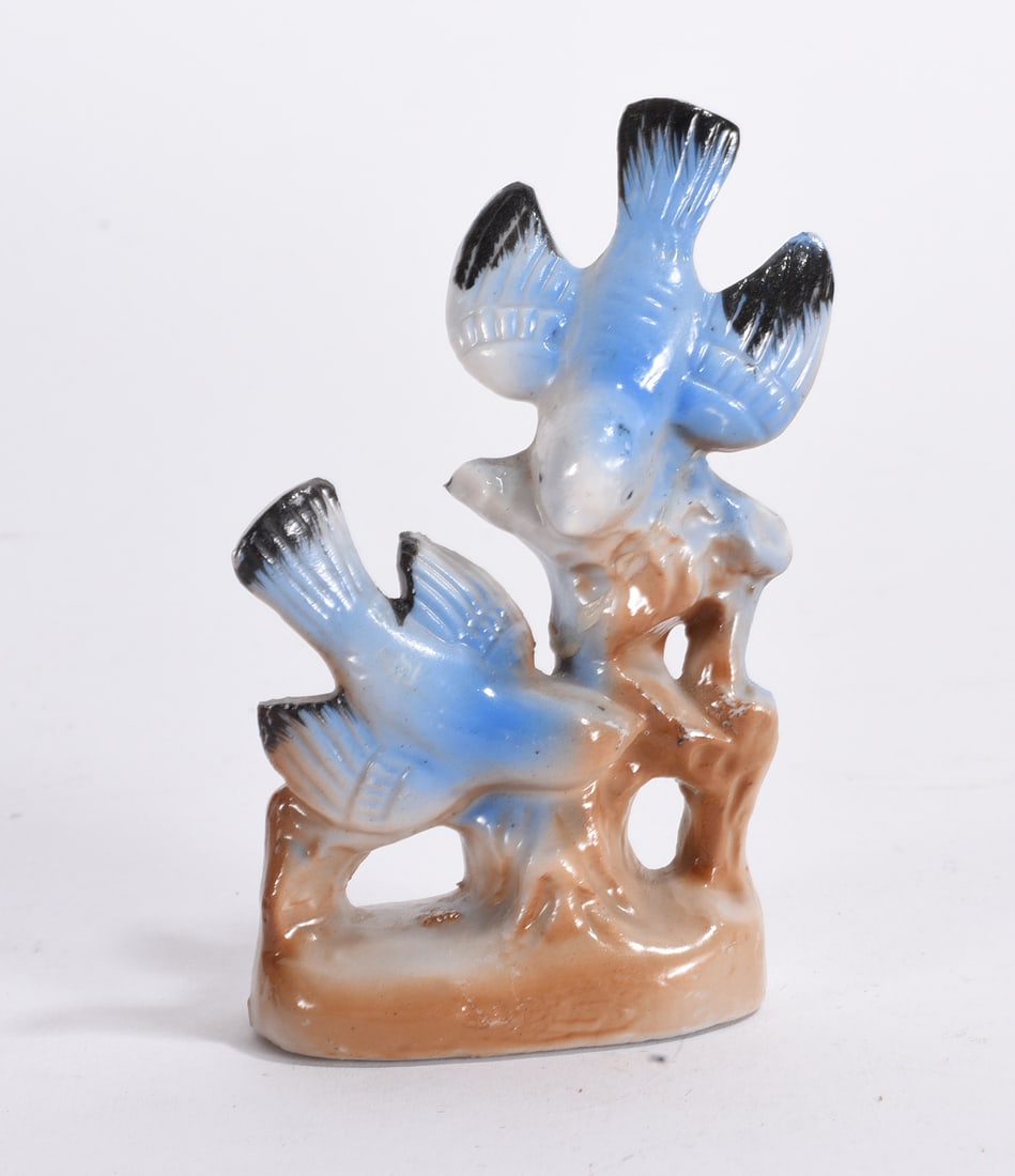 Bluebird Ceramic Figurine: Bluebird ceramic figurine group modeled perched on tree branch base with hand-painted detail.