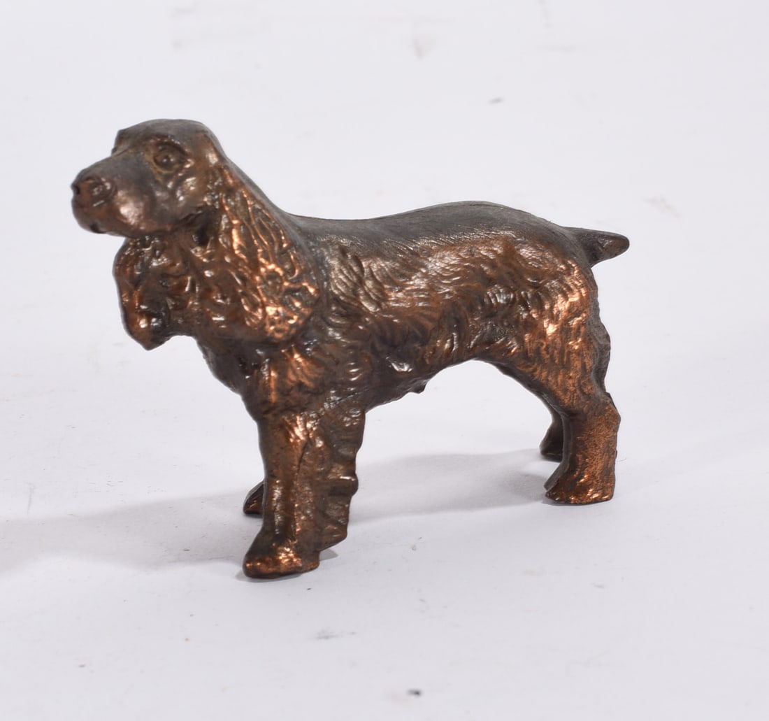 Bronze Finish Spaniel Figurine: Gold painted ceramic Pekingese dog figurine with textured fur detail and curled tail.