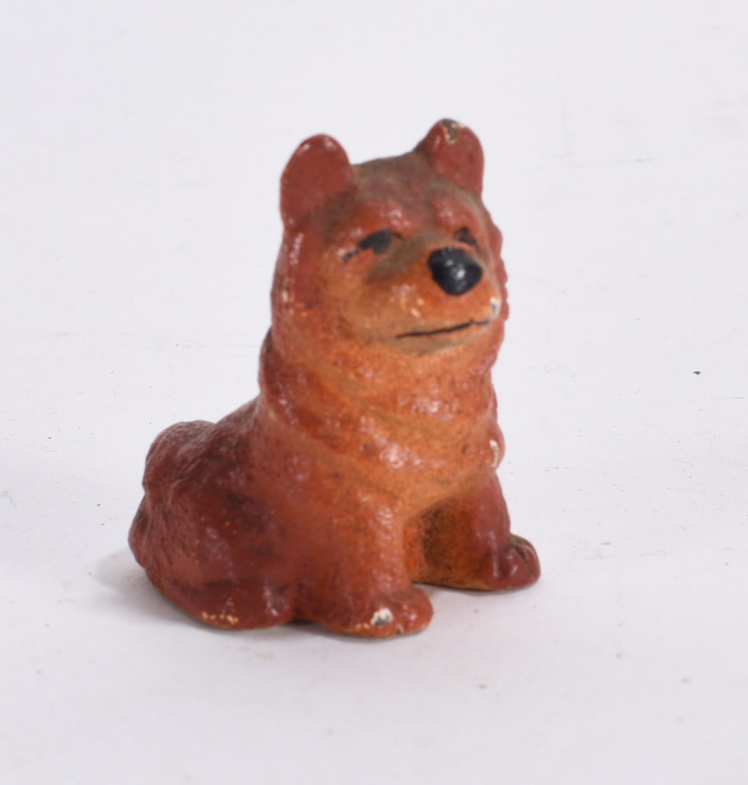 Miniature Brown Dog Figurine: Small seated dog figurine with worn painted finish and folk art styling.