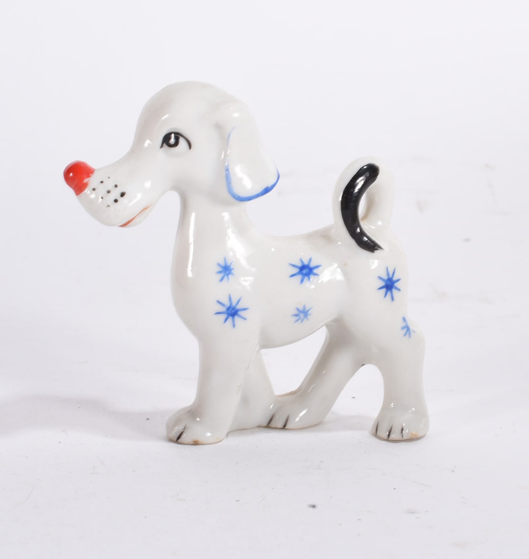 Mid-Century White Dog Figurine: Mid-century white ceramic dog figurine with blue starburst decoration and stylized form.