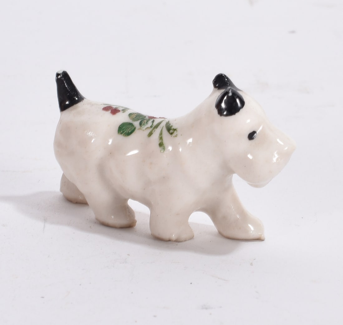 Scottie Dog Figurine: White ceramic Scottish terrier figurine with floral transfer decoration and black accents.