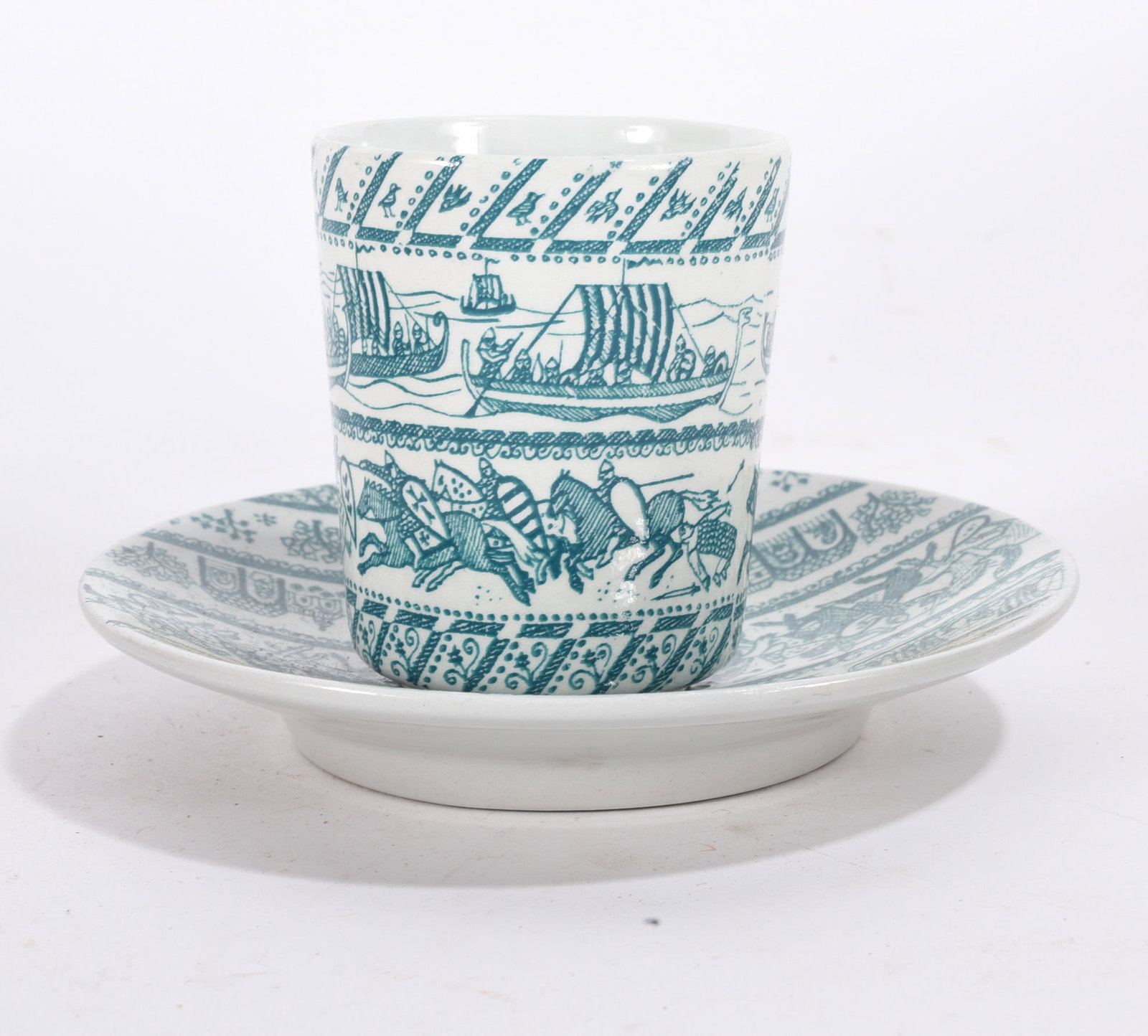 Green Transferware Cup and Saucer: Green transferware cup and saucer decorated with medieval scenes and scrolling border design.