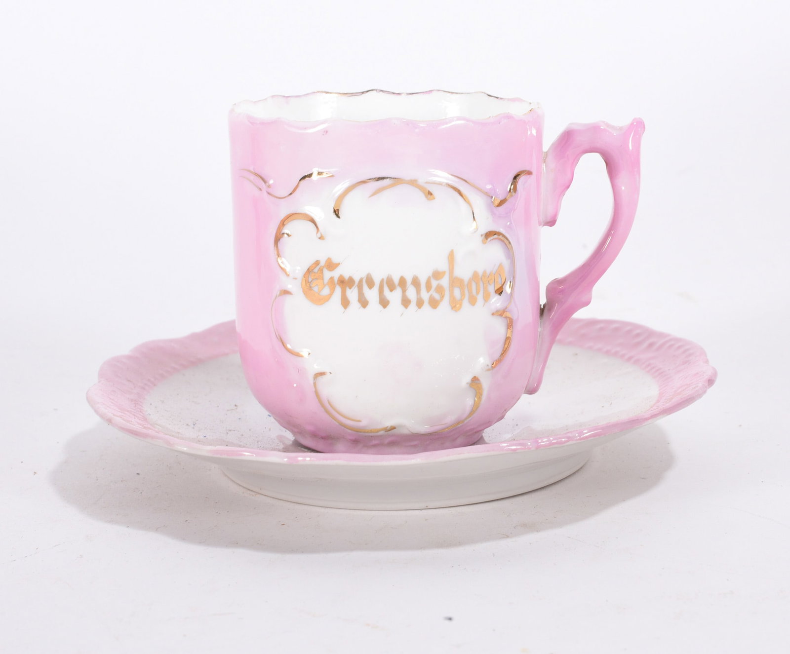 Pink ?Grimsby? Souvenir Cup and Saucer: Pink porcelain souvenir cup and saucer marked ?Grimsby? with gold gilt decoration.