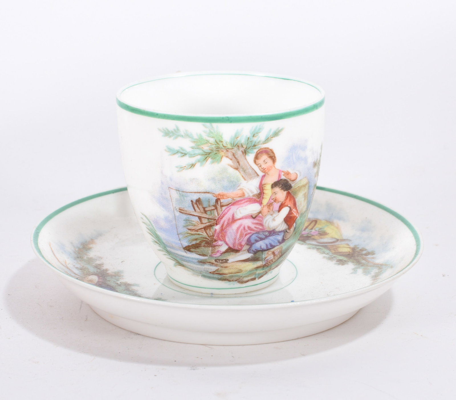 Scenic Porcelain Cup and Saucer: Porcelain cup and saucer with green trim and romantic scenic transfer decoration.