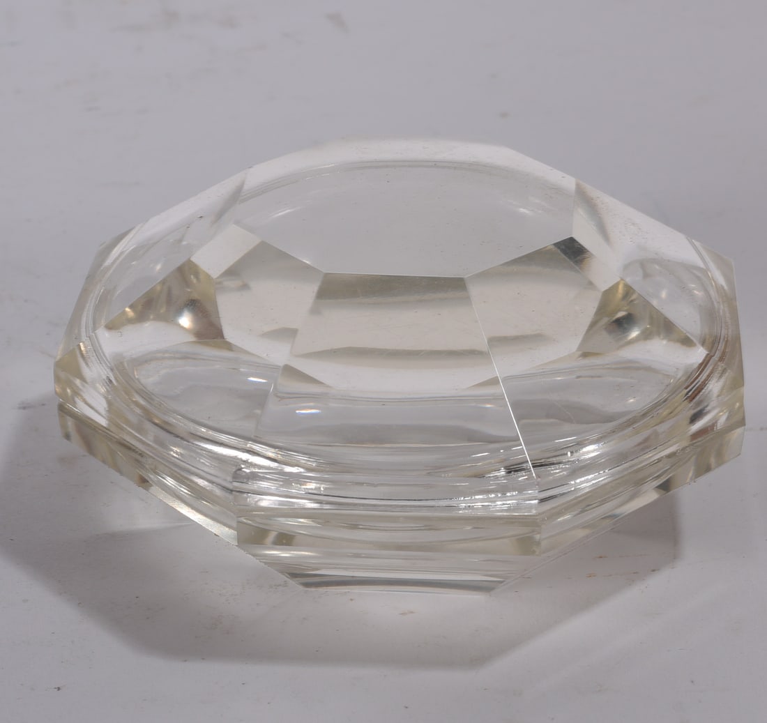 Faceted Crystal Glass Ashtray: Heavy faceted clear crystal glass ashtray with octagonal form and stepped design.