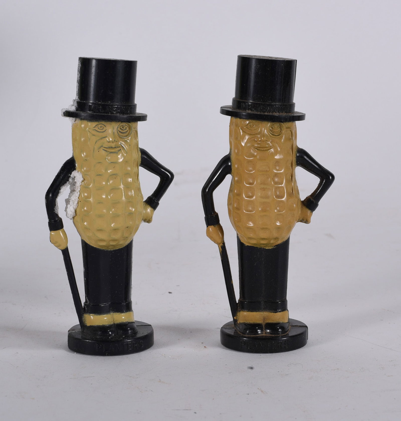 Mr. Peanut Figural Plastic Salt and Pepper Shakers: Pair of vintage Mr. Peanut figural plastic salt and pepper shakers with top hats, canes, and embossed ?Planters? bases.