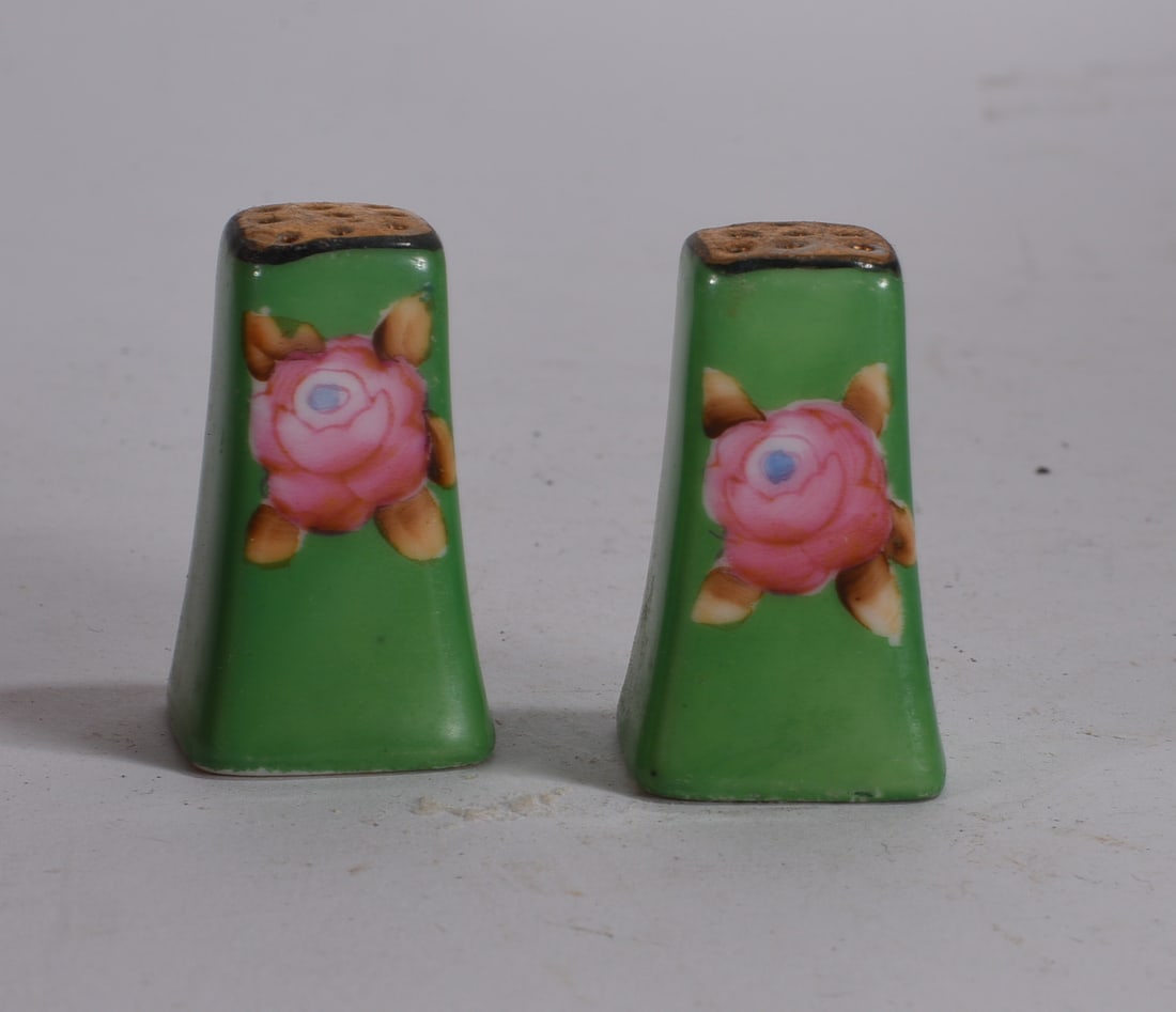 Green Floral Porcelain Salt and Pepper Shakers: Pair of green porcelain salt and pepper shakers with pink floral decoration and tapered form.