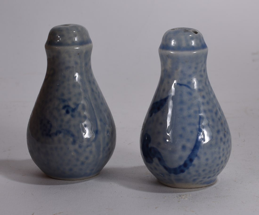 Marbled Porcelain Salt and Pepper Shakers: Pair of marbled porcelain salt and pepper shakers with bulbous form and gilt tops.