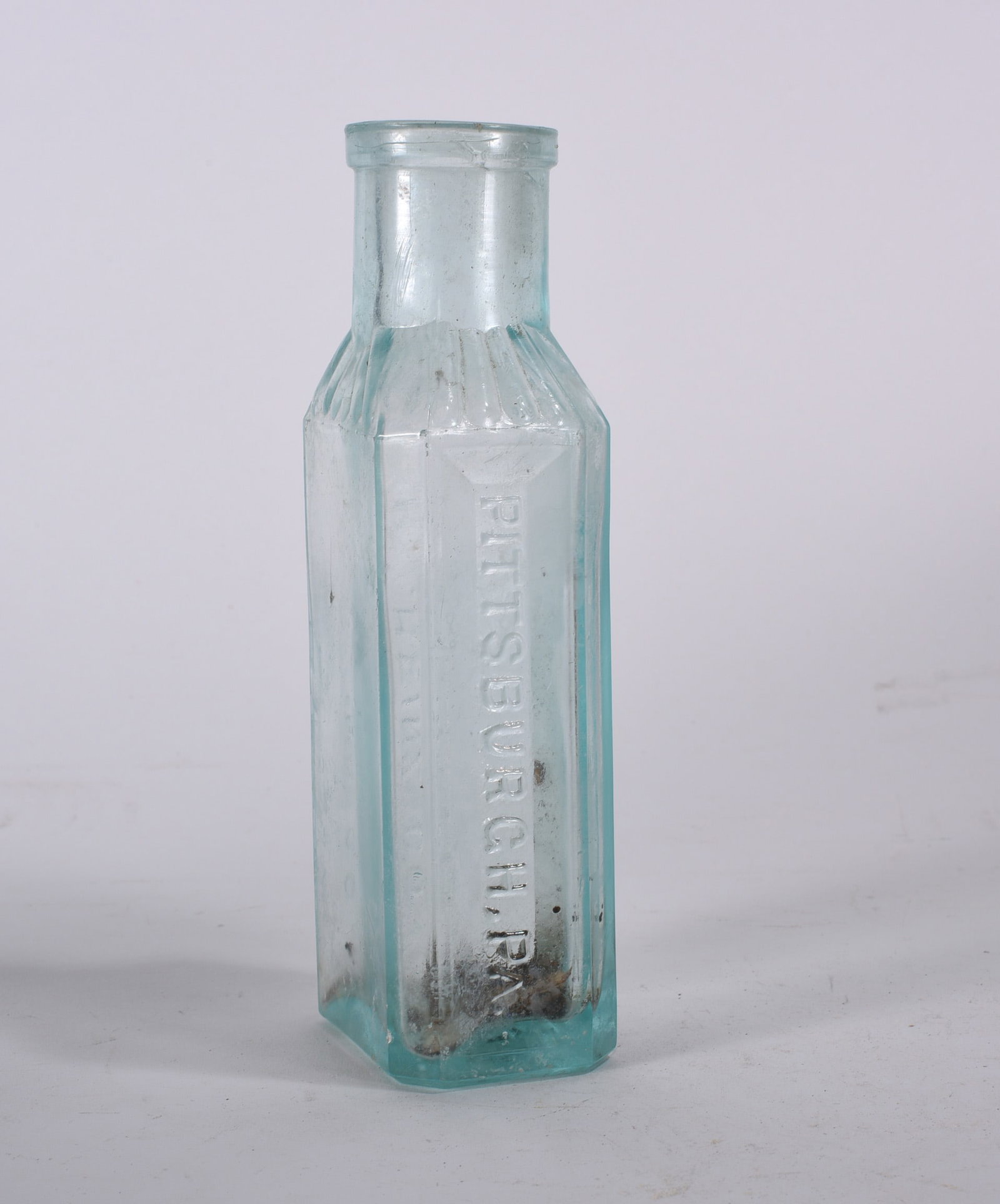 Antique Bottles: Early aqua paneled pharmacy bottle embossed ?PITTSBURGH PA? vertically to front. Ribbed shoulder with interior residue and light staining.