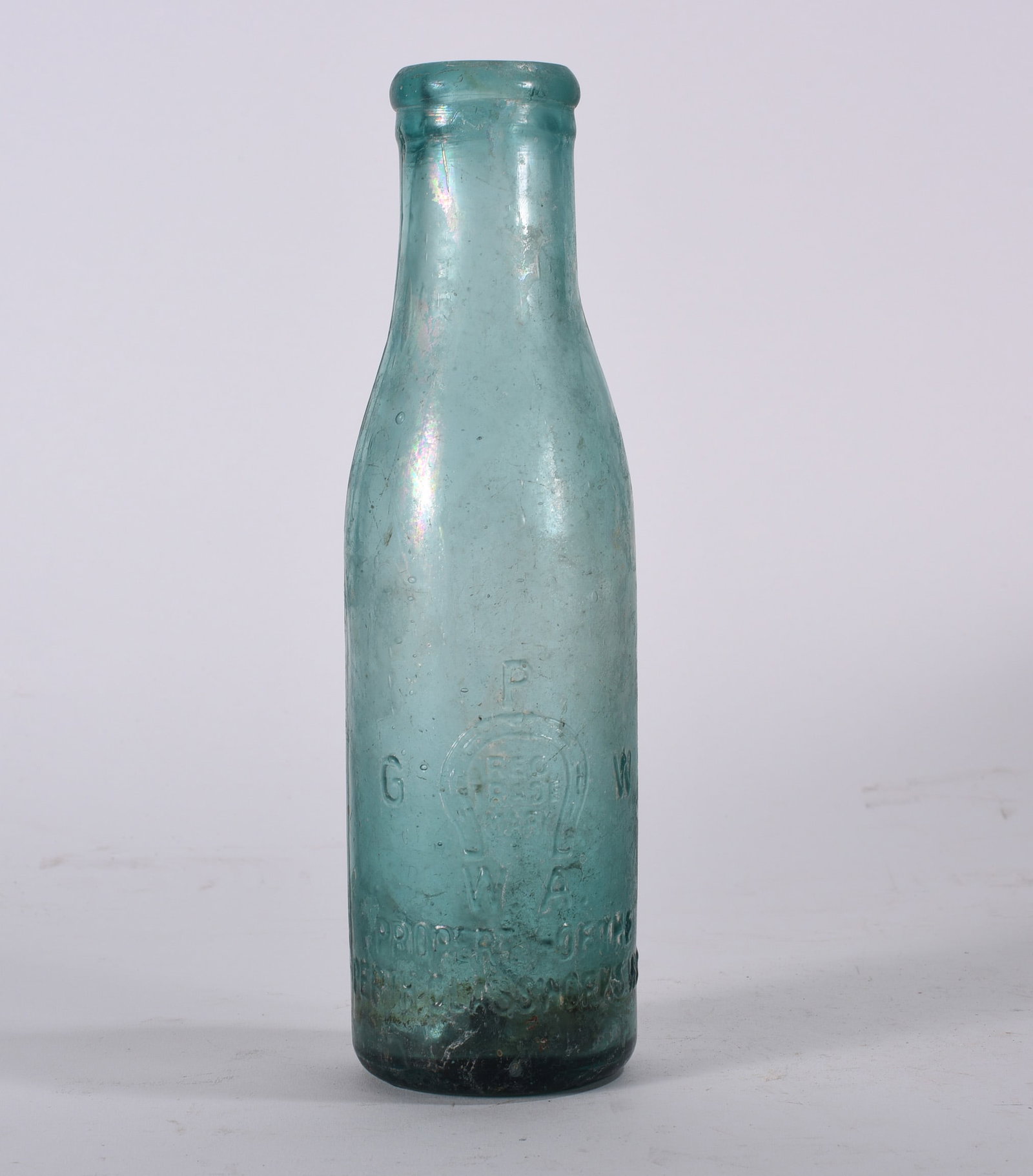 Aqua Horseshoe Trademark Soda Bottle: Antique aqua soda bottle embossed with horseshoe trademark and lettering to front. Cylindrical form with applied lip and weathered surface.