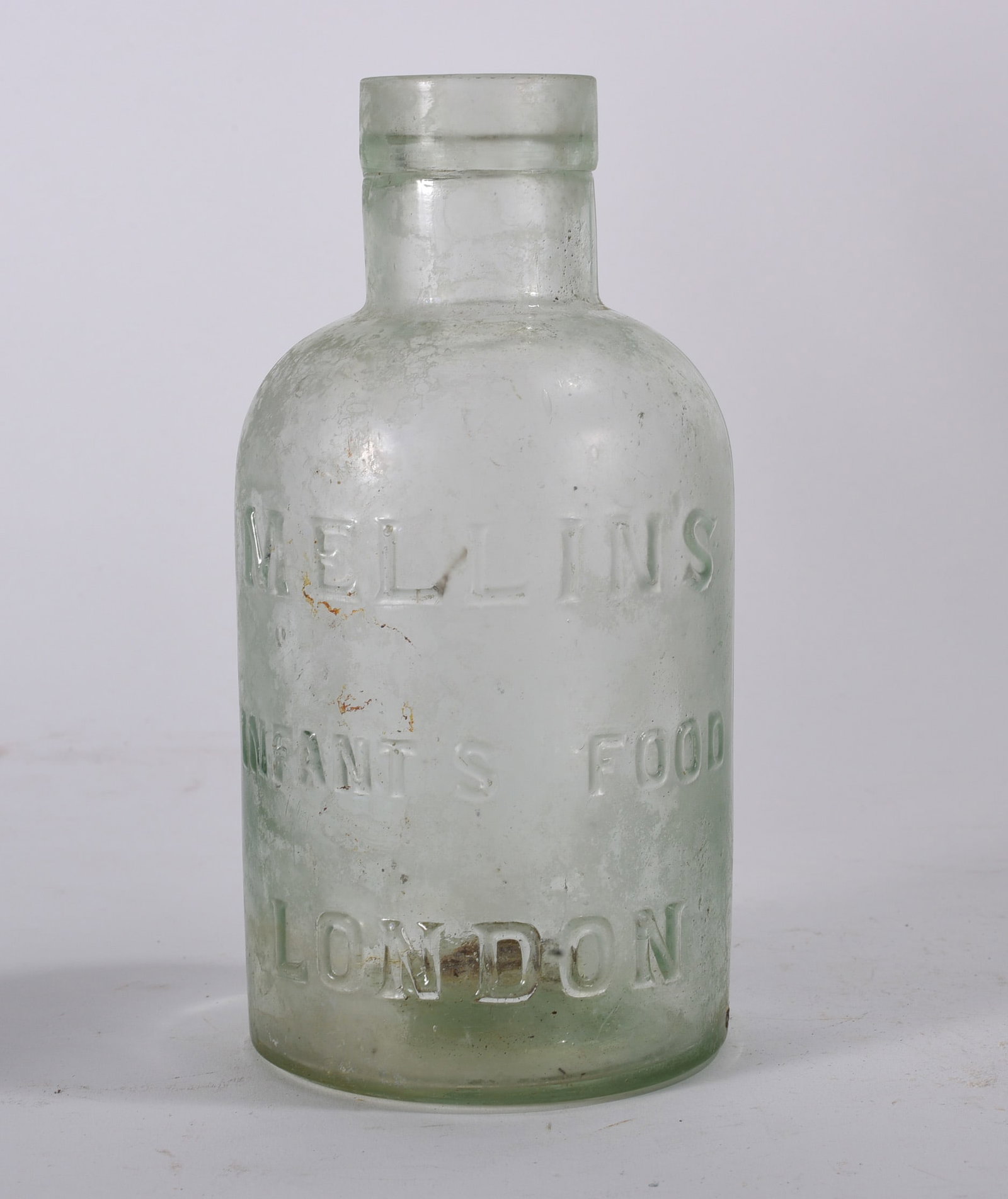 Antique Bottles: Clear embossed glass infant food jar reading ?MELLINS INFANTS FOOD LONDON.? Wide mouth form with heavy base and age wear.