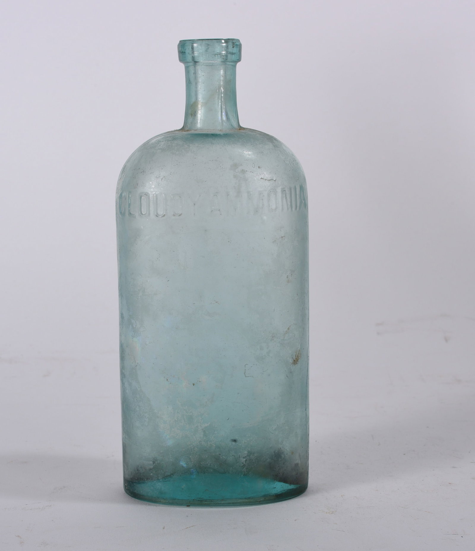 Antique Bottles: Aqua cylindrical household bottle embossed ?CLOUDY AMMONIA.? Rounded shoulder form with interior staining and surface wear.