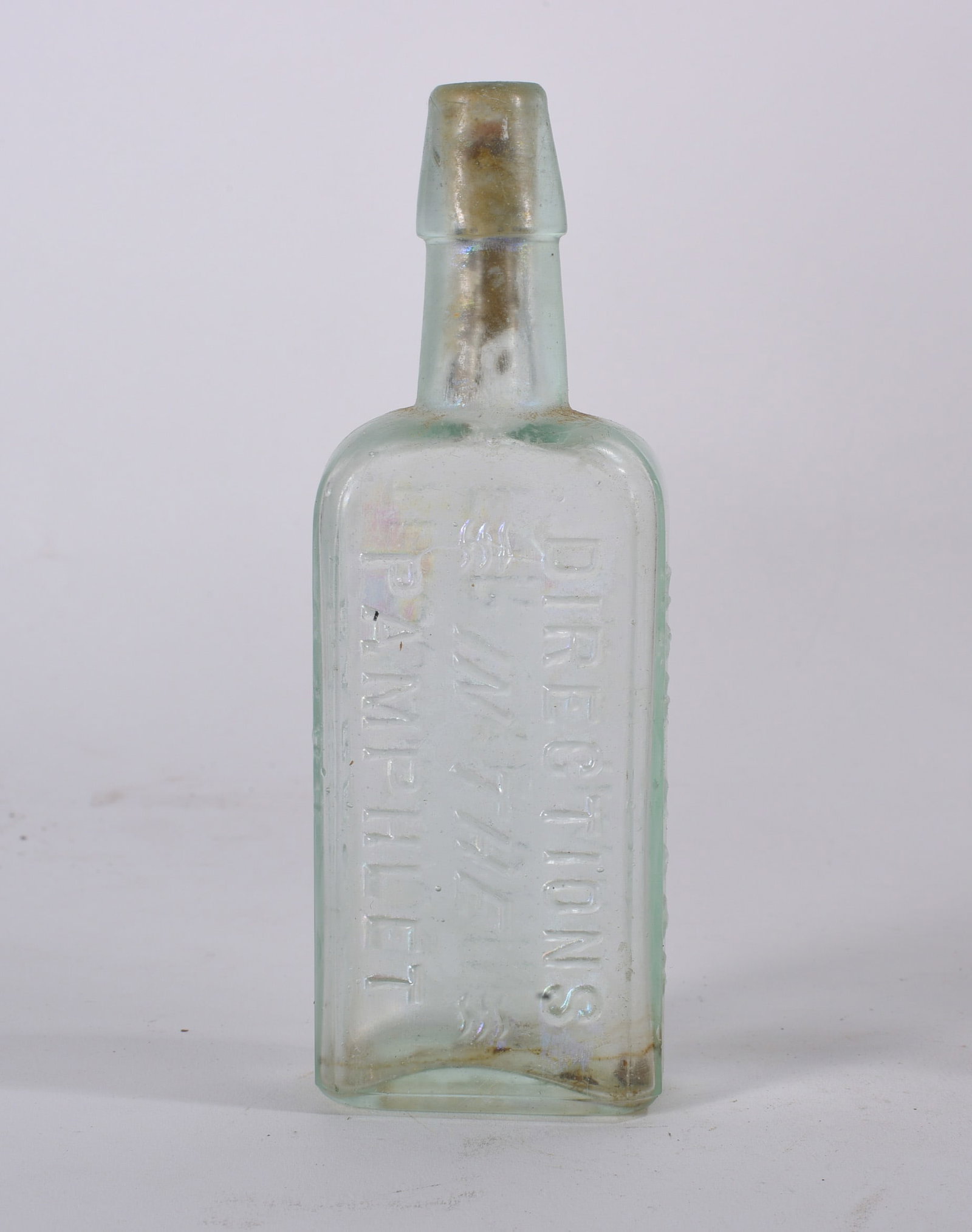 Directions Pamphlet Medicine Bottle: Antique rectangular medicine bottle embossed ?E. HOLLAND HAIR SPECIALIST MELBOURNE.? Clear aqua glass with heavy interior staining and ground wear.