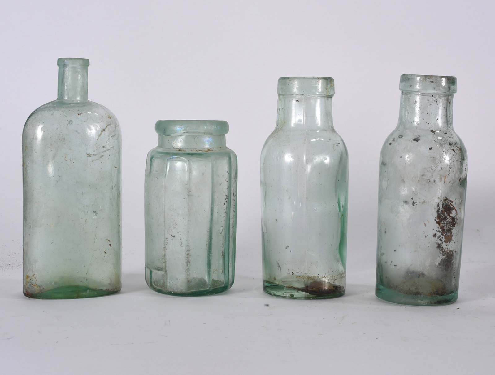Assorted Antique Medicine Bottle Group: Group lot of assorted antique medicine and utility bottles including embossed pharmacy examples. Various forms, sizes, and conditions with wear from use and storage.