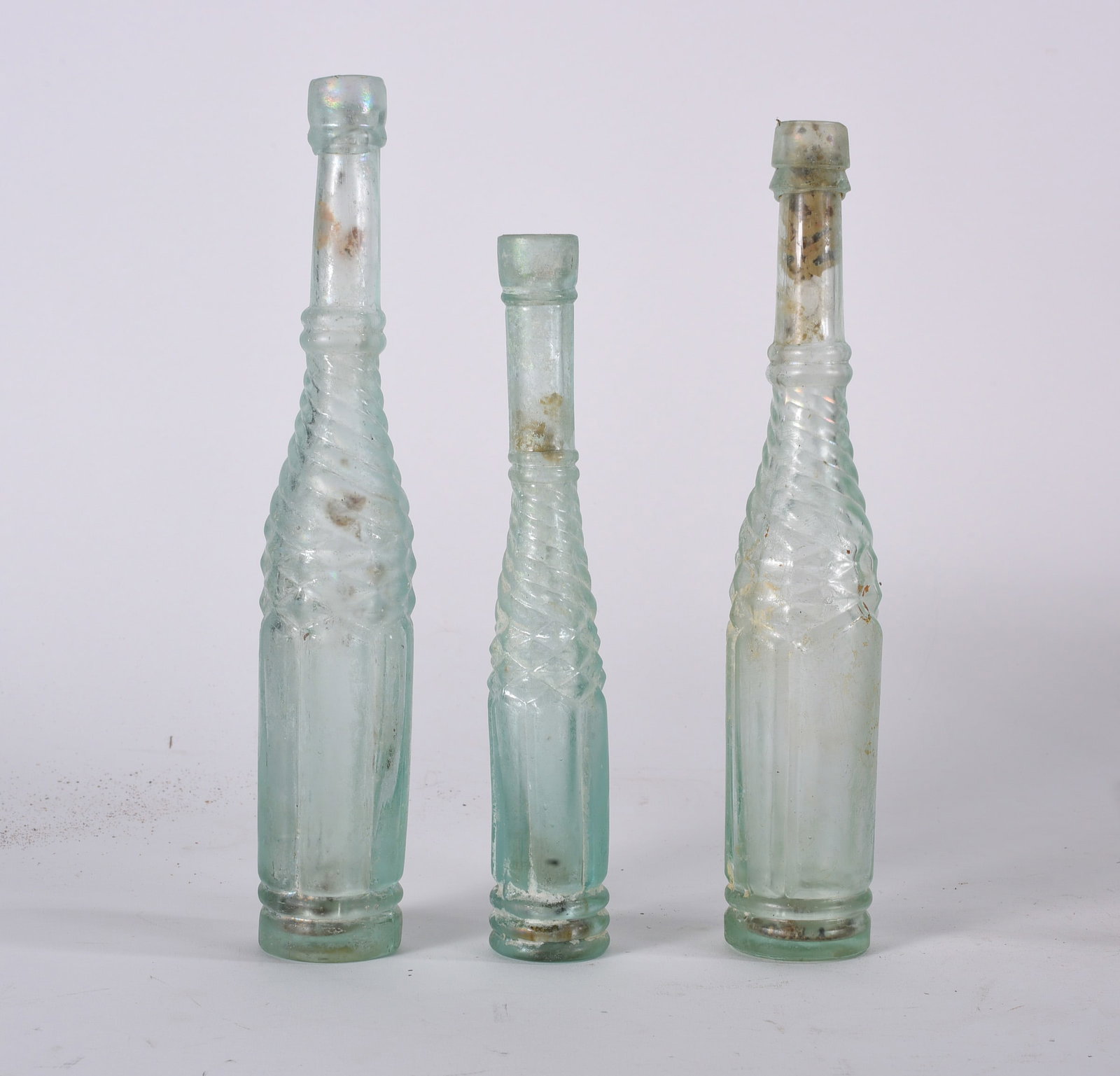 Assorted Iridescent Decorative Bottles: Collection of cobalt blue apothecary and medicine bottles in assorted forms and sizes. Some examples showing strong iridescence and embossed lettering.