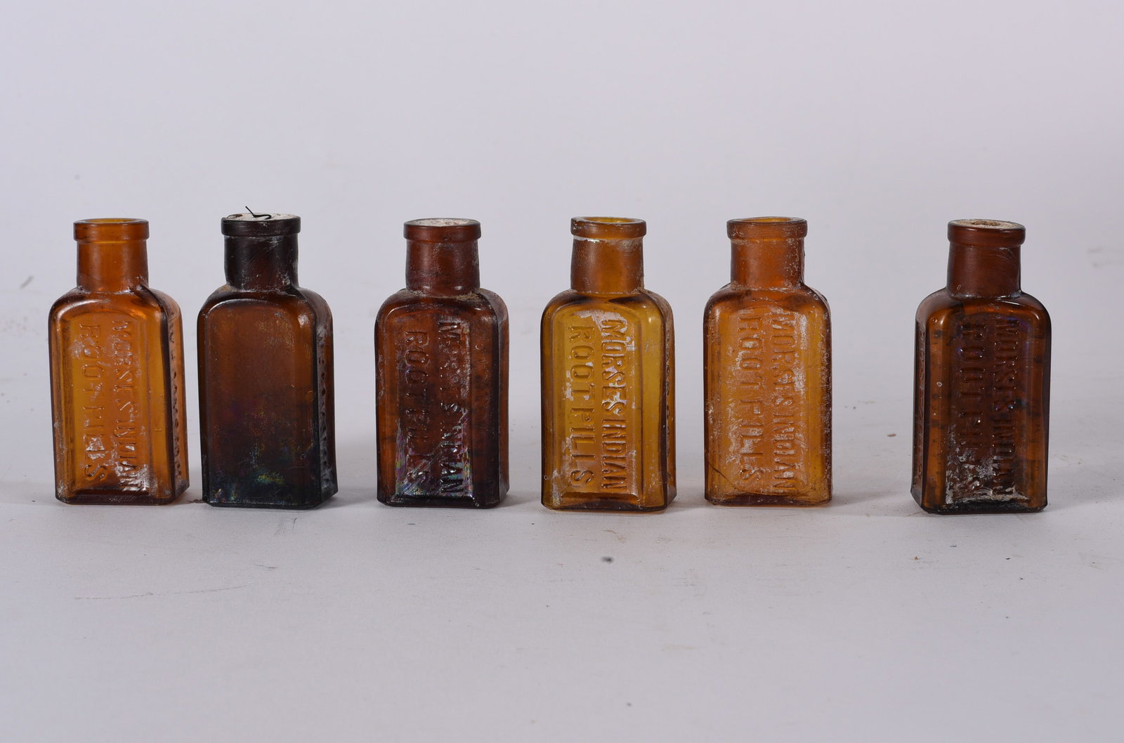 Antique Bottles: Three matching aqua embossed medicine bottles reading ?DREFTONS PAMPHLET.? Rectangular forms with applied lips and visible age-related staining.