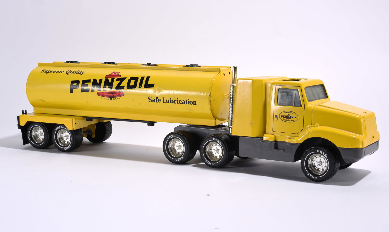 Ertl Pennzoil Tanker Truck Toy: Ertl pressed steel Pennzoil tanker truck toy with articulated trailer. Bright yellow advertising graphics and chrome-tone wheels. Light play wear overall.