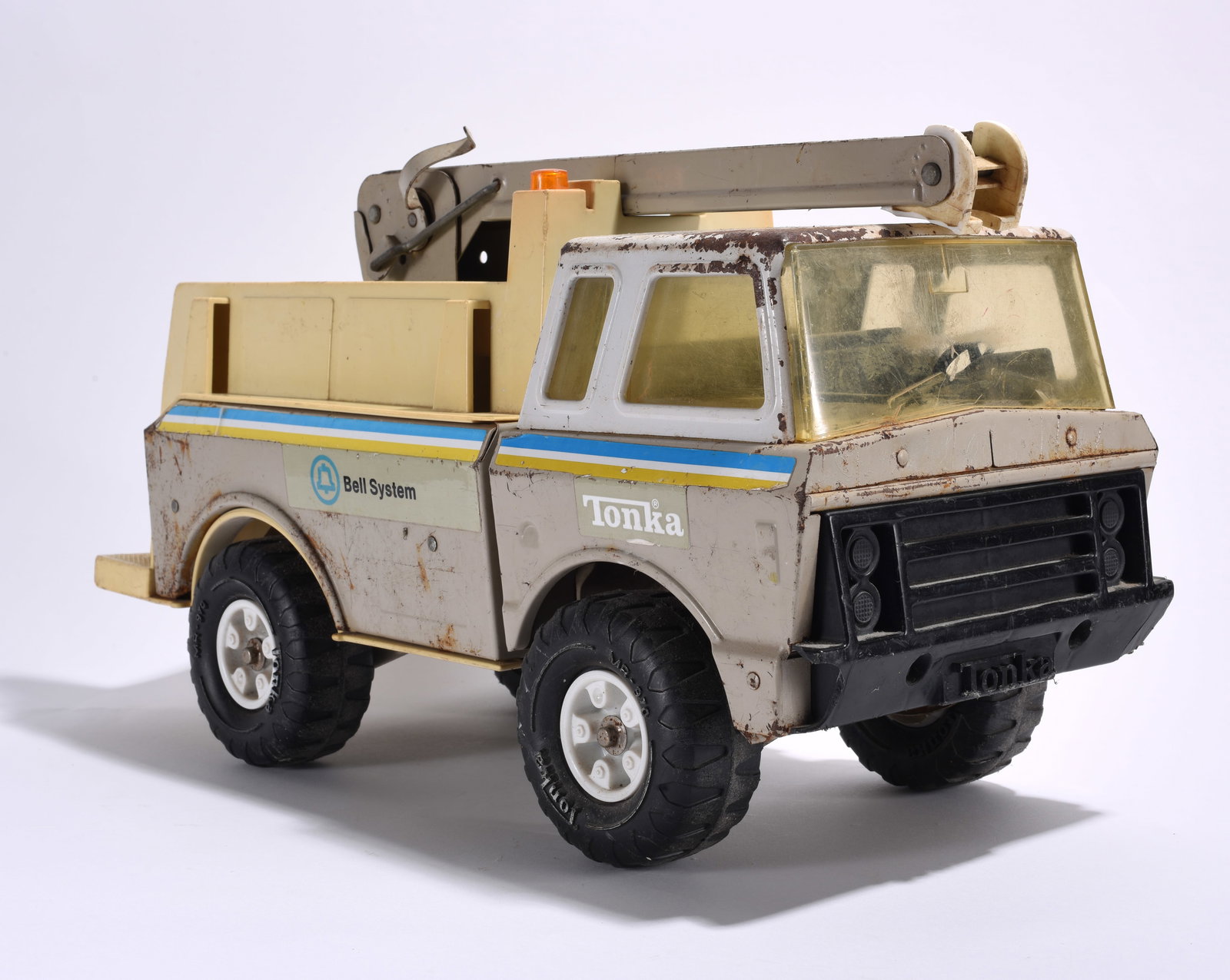 Tonka Bell System Utility Service Truck: Tonka Bell System utility service truck with boom attachment. Pressed steel construction with plastic cab windows and Bell System graphics. Moderate wear from use and age.