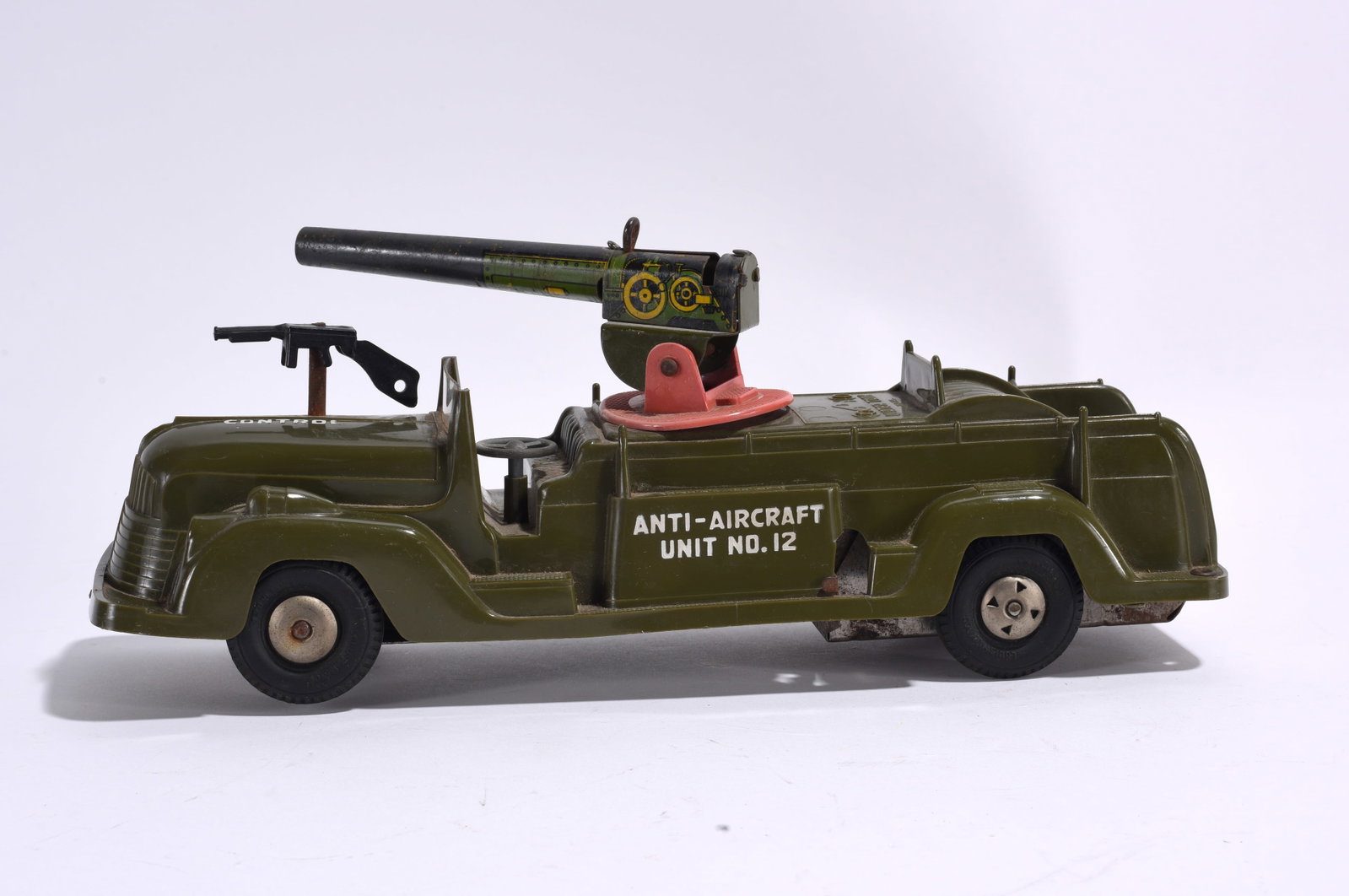 Anti-Aircraft Unit No. 12 Military Toy Vehicle: Vintage Anti-Aircraft Unit No. 12 military toy vehicle with mounted rotating cannon. Olive drab finish with lithographed detailing and visible play wear throughout.