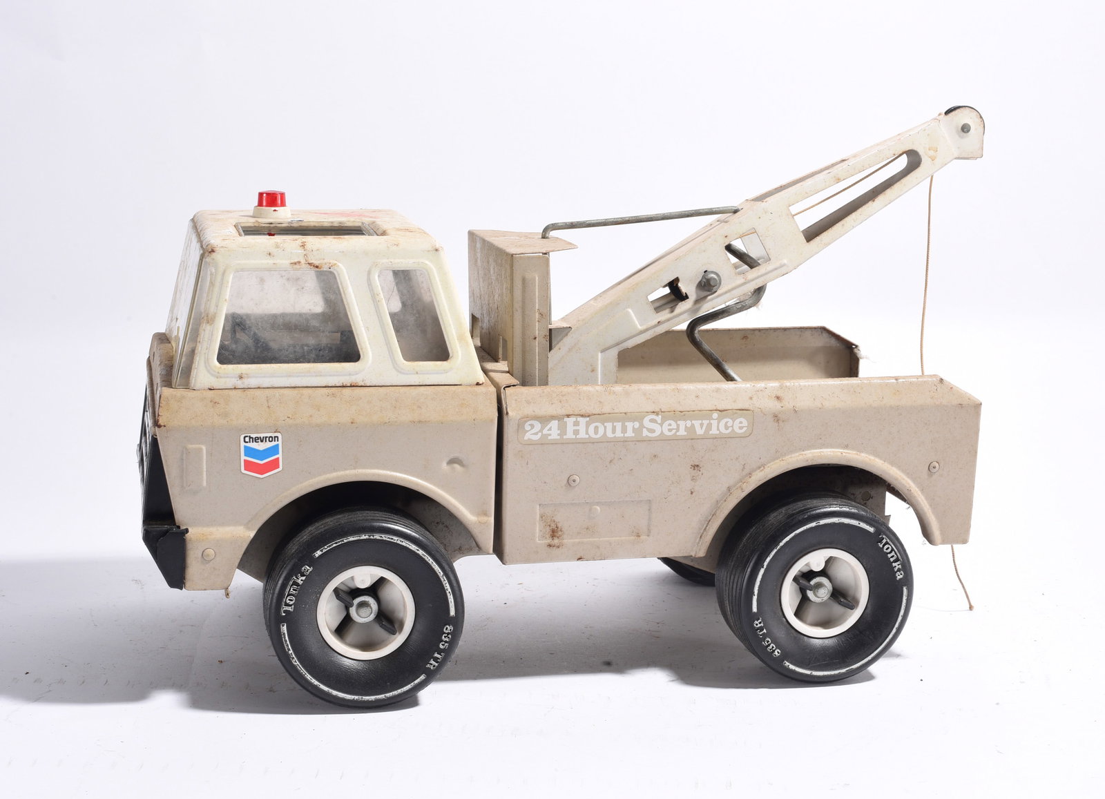 Tonka Chevron 24 Hour Service Wrecker Truck: Tonka Chevron 24 Hour Service wrecker truck with tow boom assembly and emergency beacon light. Cream finish with original Chevron graphics and moderate handling wear.
