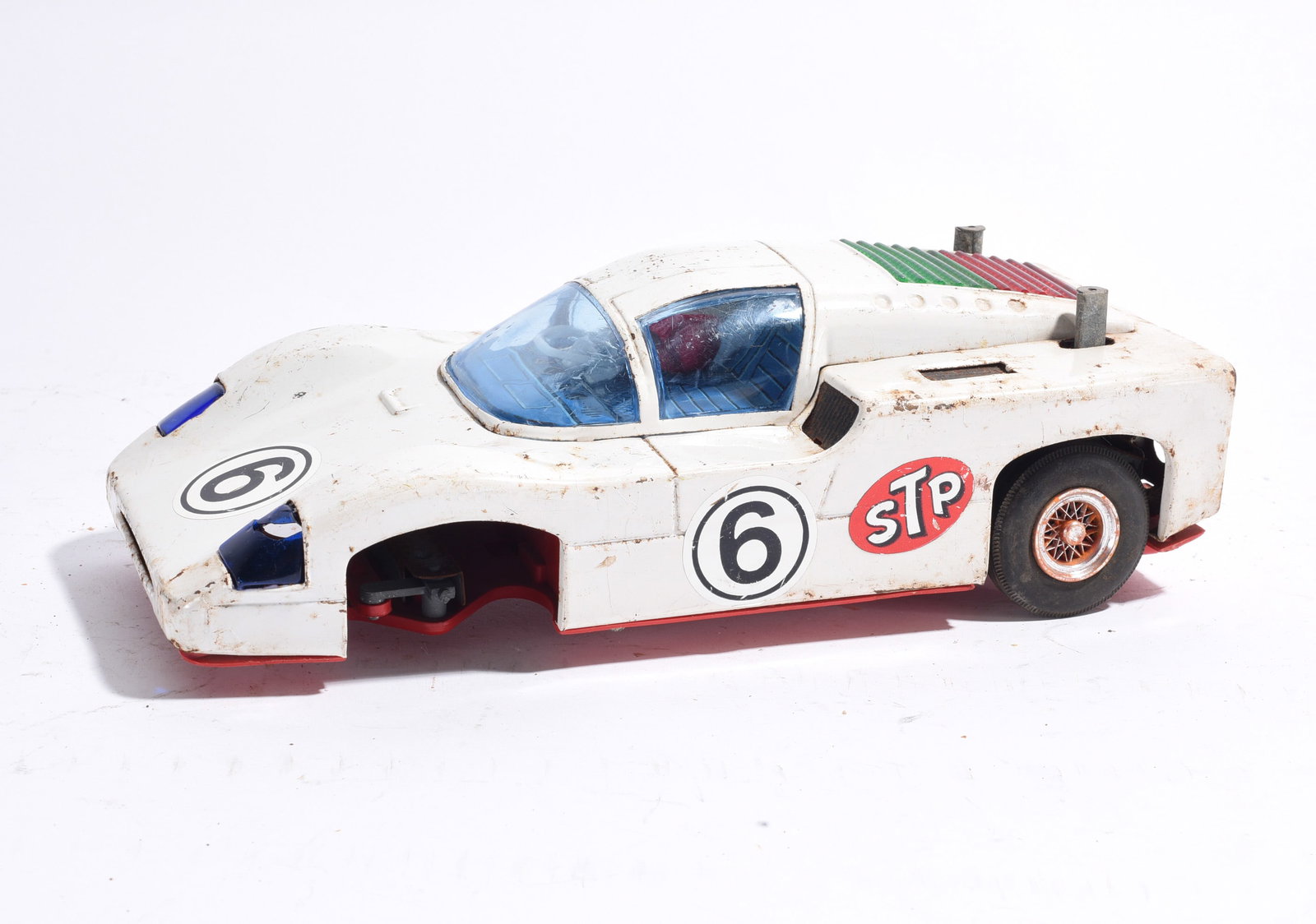 STP No. 6 Endurance Race Car Toy: STP No. 6 endurance-style race car toy with white body and racing graphics. Plastic construction with visible dirt, scratches, and handling wear.