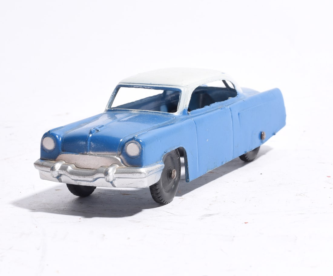 Plastic Two-Tone Sedan Toy Car: Plastic sedan toy automobile in blue with white roof and silver-toned bumper details. Mid-century styling with rolling wheels and molded body features. Light wear from age and handling.