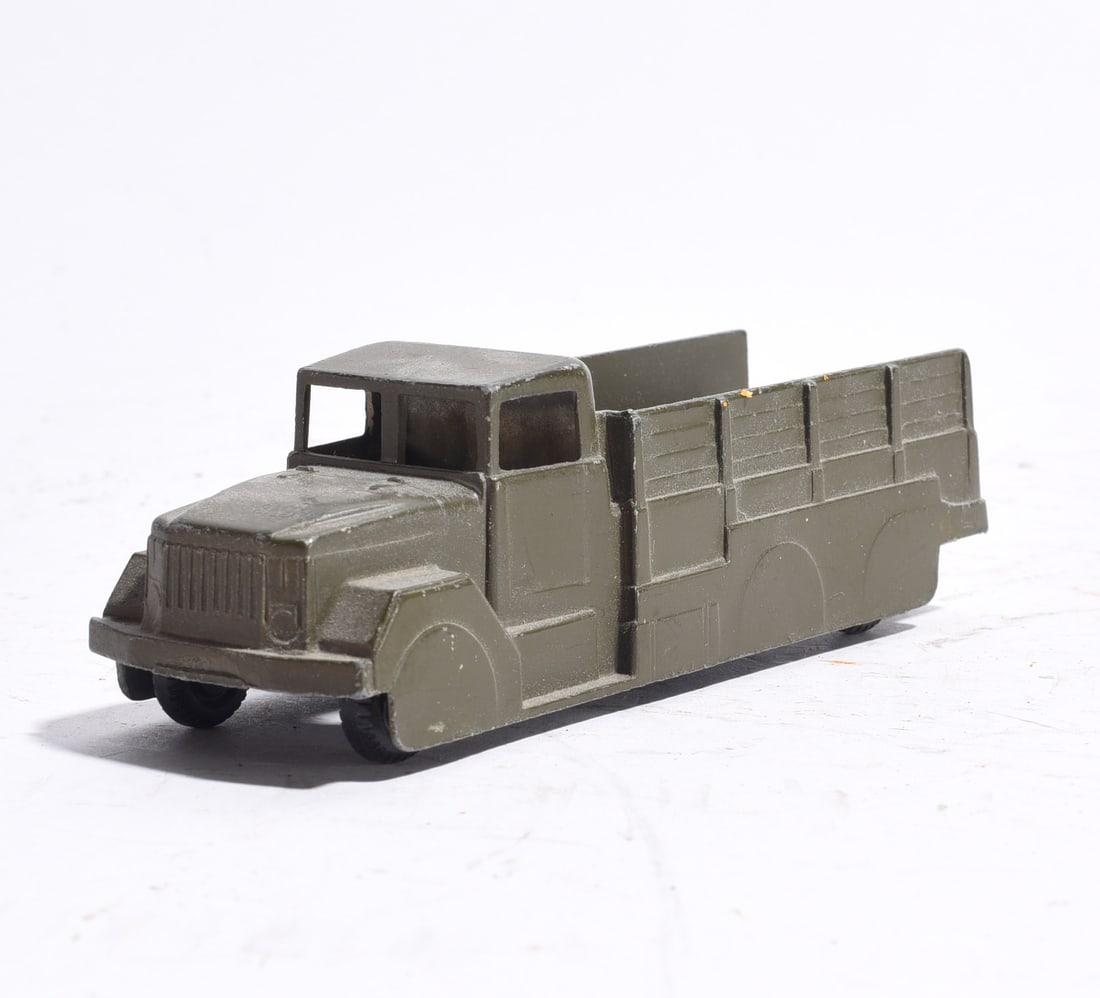 Military Cargo Transport Truck: Military-style transport truck in olive drab finish with enclosed cab and stake-sided cargo body. Molded military vehicle design with rolling wheels. Light wear and age-related handling marks present.