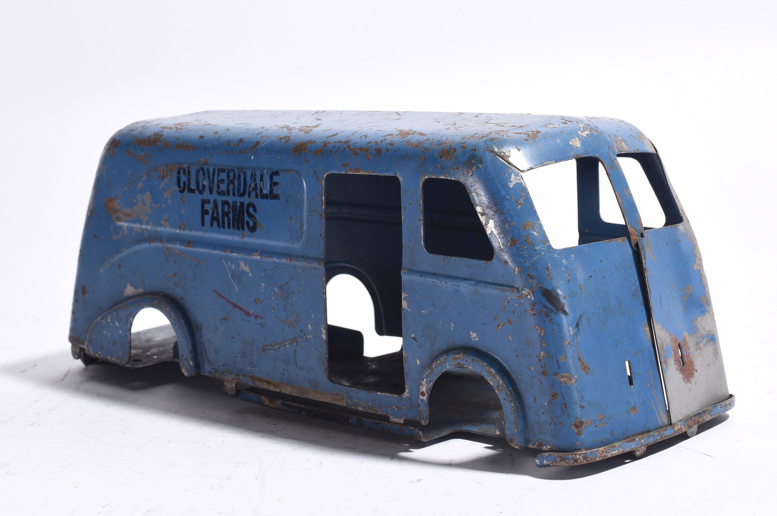 Cloverdale Farms Pressed Steel Delivery Van Body: 148. Cloverdale Farms pressed steel delivery van body shell finished in blue with black advertising graphics. Lacking chassis and running gear. Exhibits oxidation, paint loss, and age-related wear thr