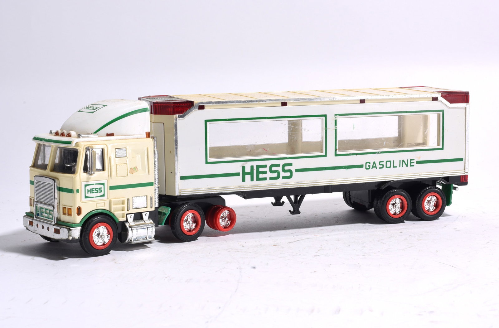 Hess Gasoline Tractor Trailer: 155. Hess gasoline tractor trailer featuring detailed cab, tandem-axle trailer, and original Hess graphics. Complete with chrome-style wheel accents and rolling wheels. Displays light play and