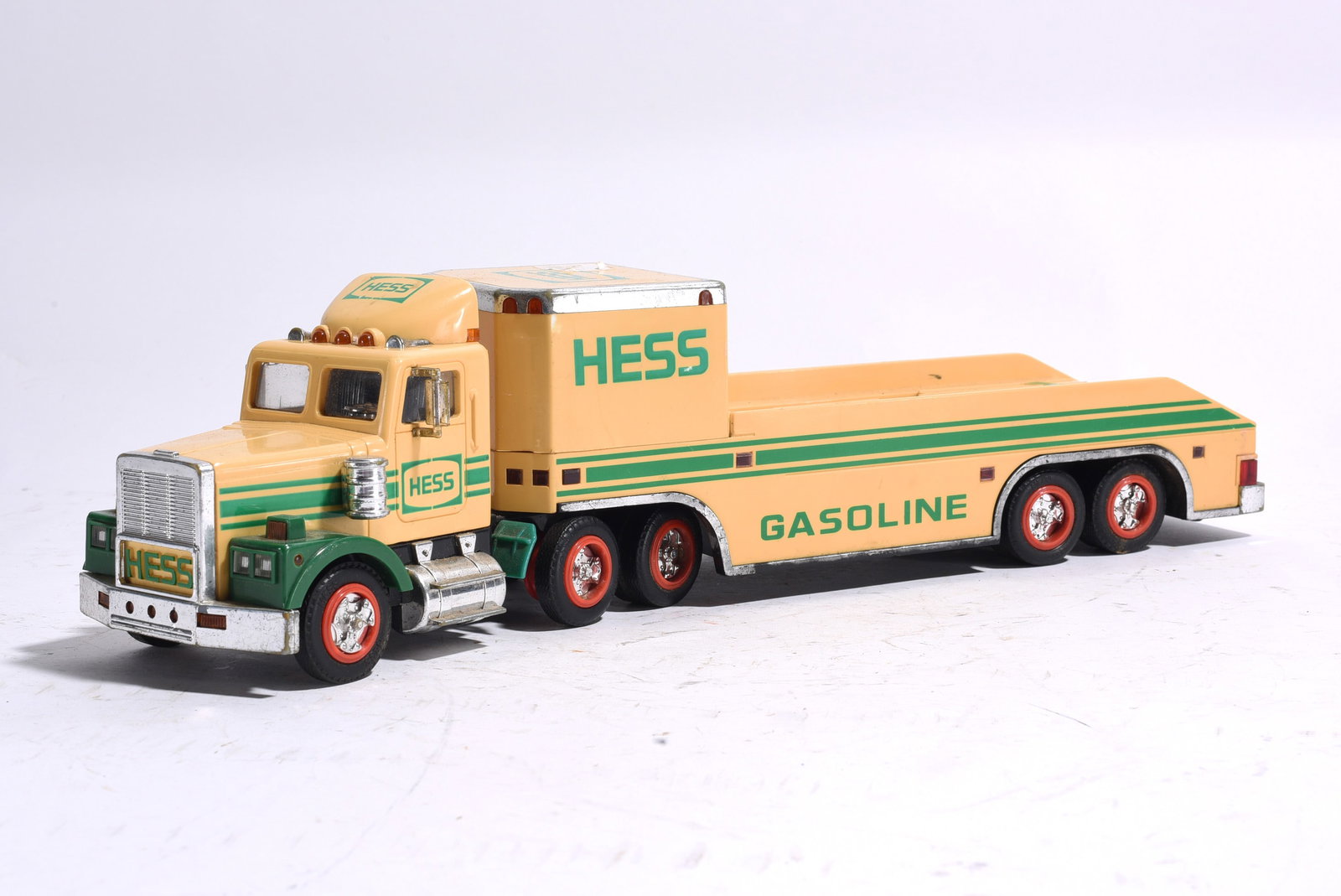 Hess Fuel Tanker Truck: Hess Fuel Tanker Truck with tandem-axle tractor and cylindrical fuel tank trailer. Retains original Hess Gasoline graphics and molded details. Minor wear from age and display.