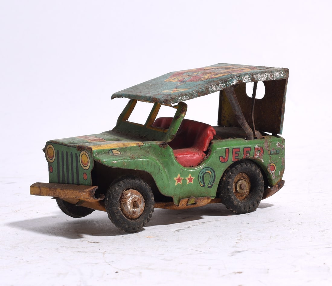 Vintage Tin Jeep Utility Vehicle: Vintage tin lithograph Jeep utility vehicle with canopy roof, painted graphics, and pressed steel construction. Exhibits rust, paint loss, and wear from use and storage.