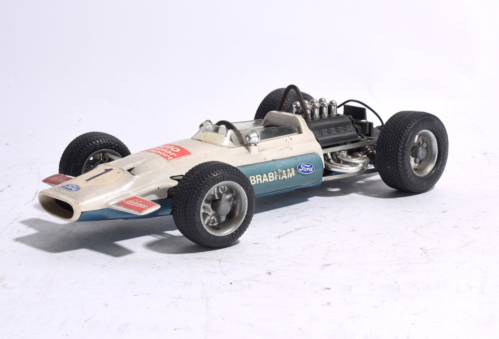 Brabham Ford Formula One Race Car No. 1: Brabham Ford Formula One race car marked No. 1 with exposed rear engine detail, racing decals, and rubber tires. Shows light wear from play and display.
