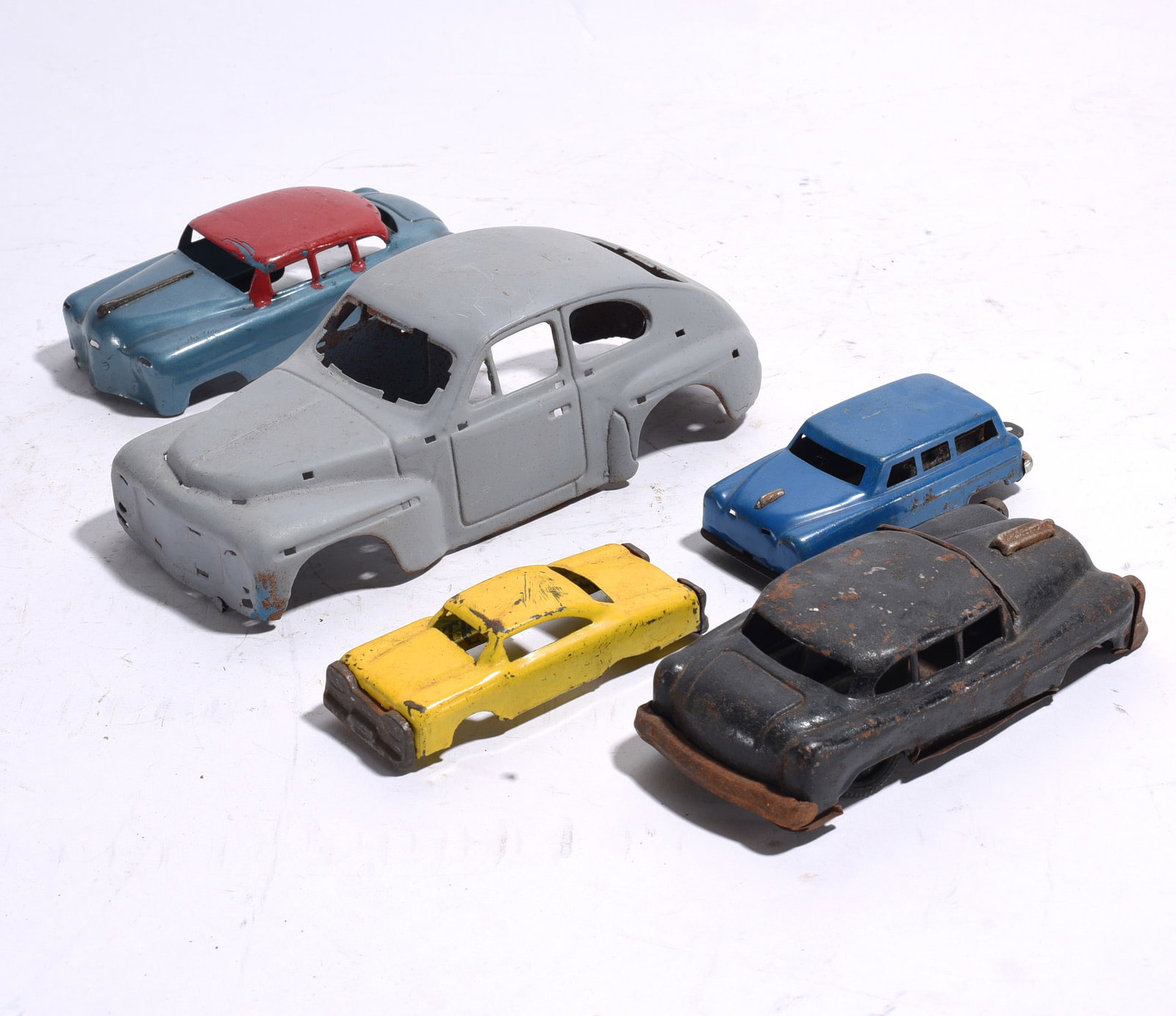 Group of Five Assorted Hess and Promotional Toy Vehicles: Group of five promotional and toy vehicles including multiple Hess gasoline trucks and transporters. Includes tanker, flatbed, and service vehicle examples showing light to moderate display and play