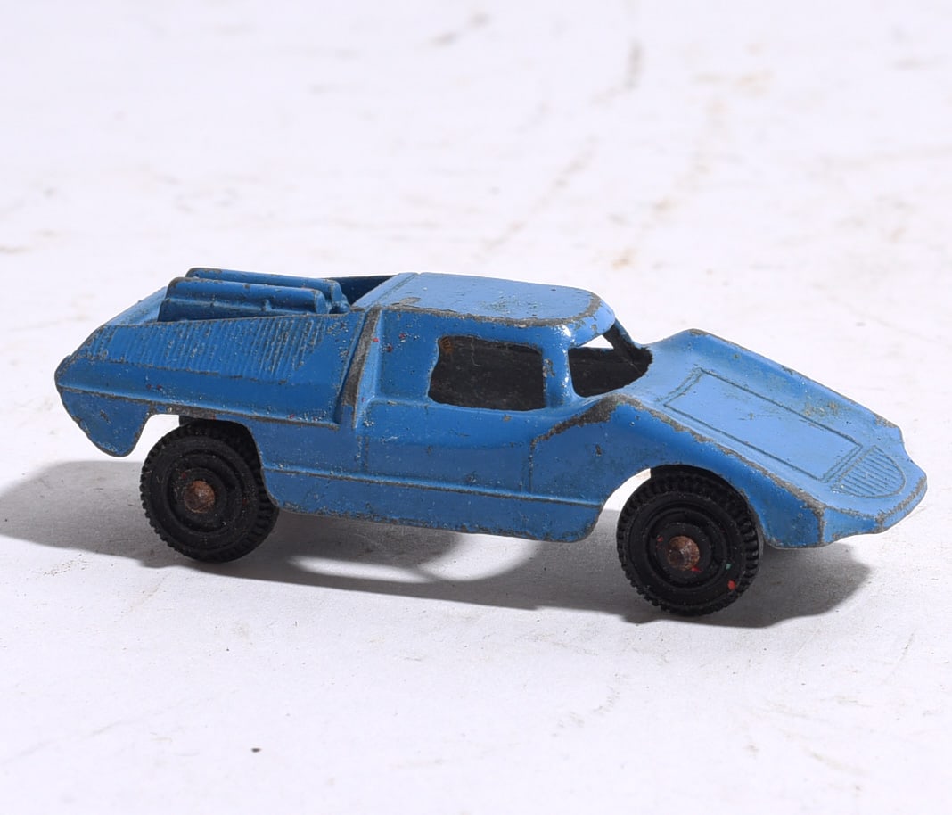 Blue Die-Cast Utility Pickup Truck: Blue die-cast utility pickup truck with integrated rear equipment compartment. Displays paint wear, oxidation, and use consistent with age.