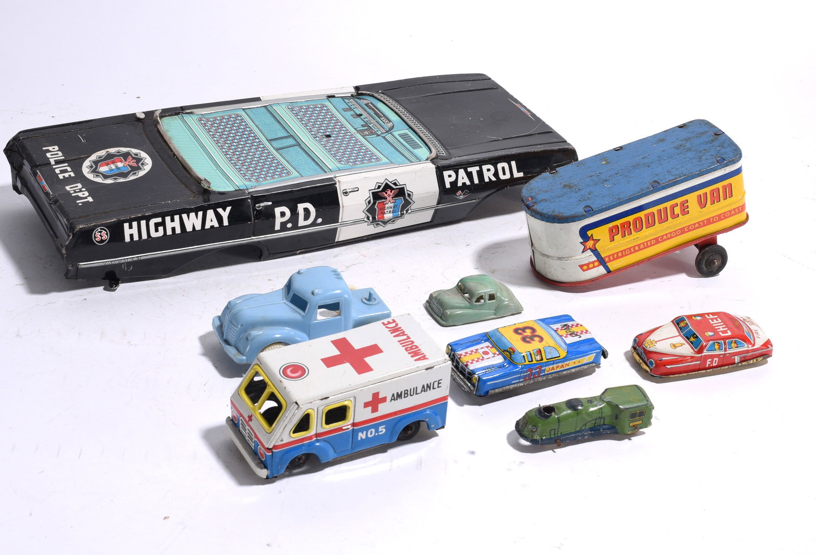 Assorted Tin Lithograph Toy Vehicle Group: Group of assorted tin lithograph toy vehicles including a Highway Patrol car body, Produce Van trailer, ambulance, race car, coupe, streamliner, and truck cab. Mixed sizes and makers. Wear and losses 