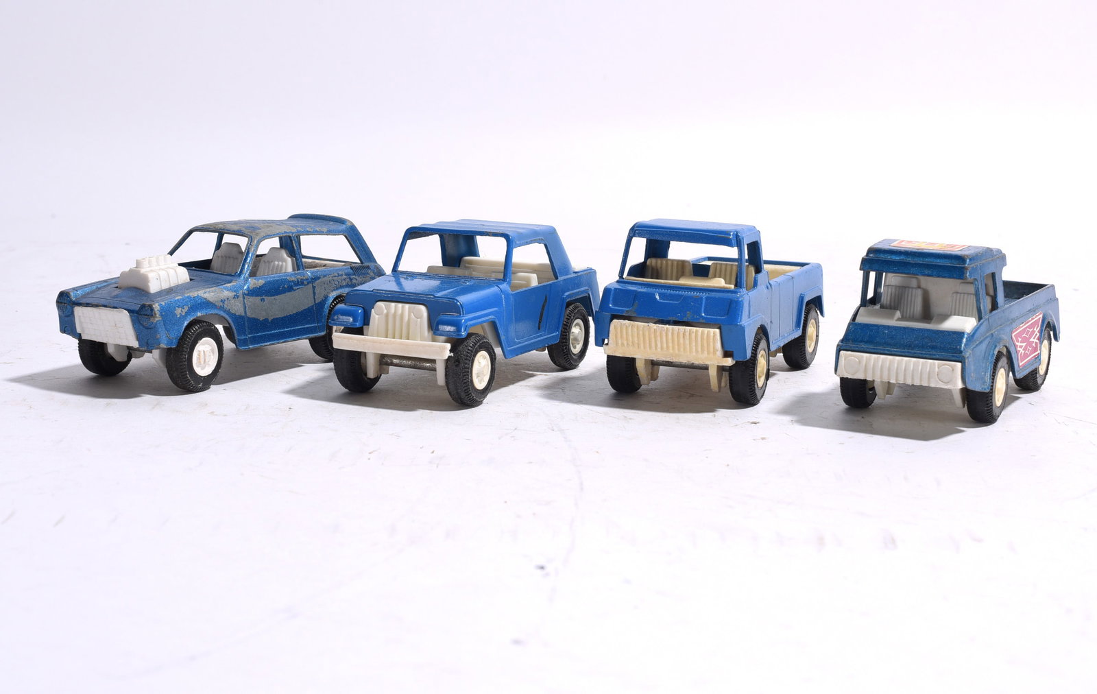 Group of Four Plastic Utility Vehicles (1 of 1)