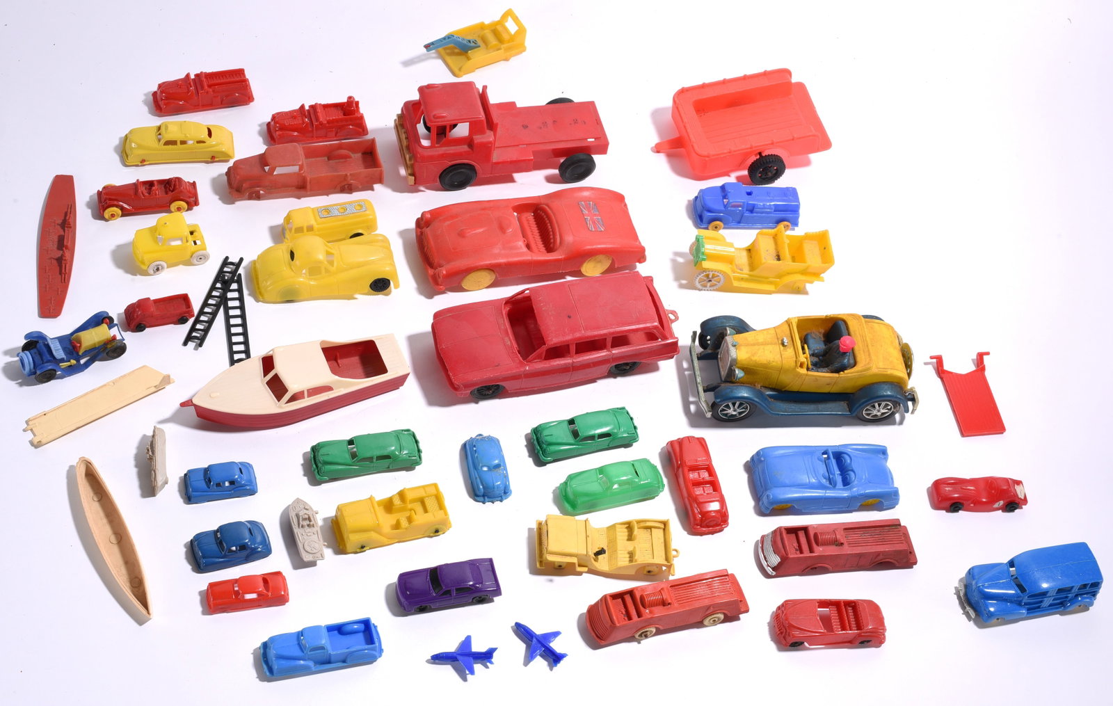 Assorted Plastic Toy Vehicles and Accessories: Assorted plastic toy vehicles and accessories including automobiles, trucks, boats, trailers, airplanes, and miscellaneous parts. Mixed colors, sizes, and condition.