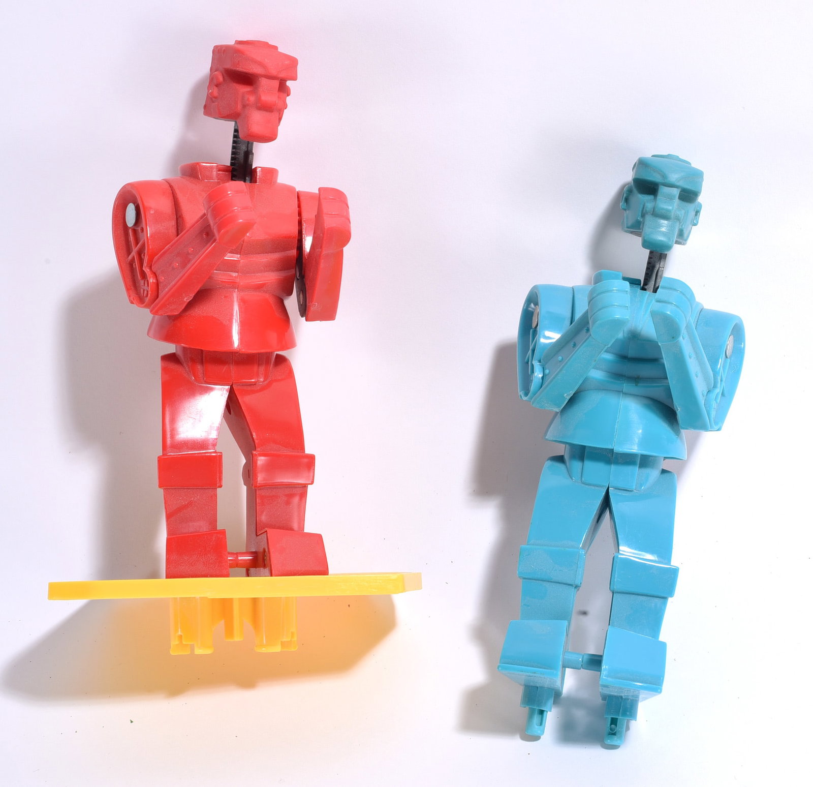 Plastic Robot Figure Group: Group of two articulated plastic robot figures in red and blue molded plastic construction. Includes one example mounted to a display base. Light wear from handling and play.