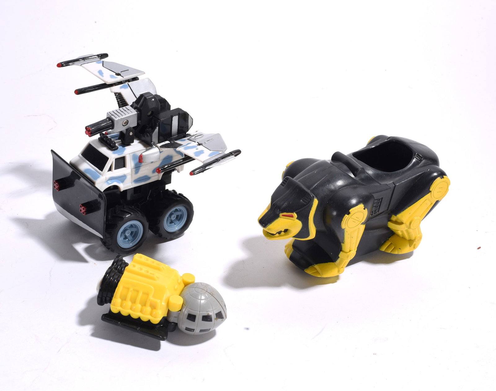 Assorted Futuristic and Action Toy Vehicles: Group of three futuristic and action-themed toys including armored vehicle, tracked spacecraft, and robotic animal vehicle. Plastic construction with light play wear.