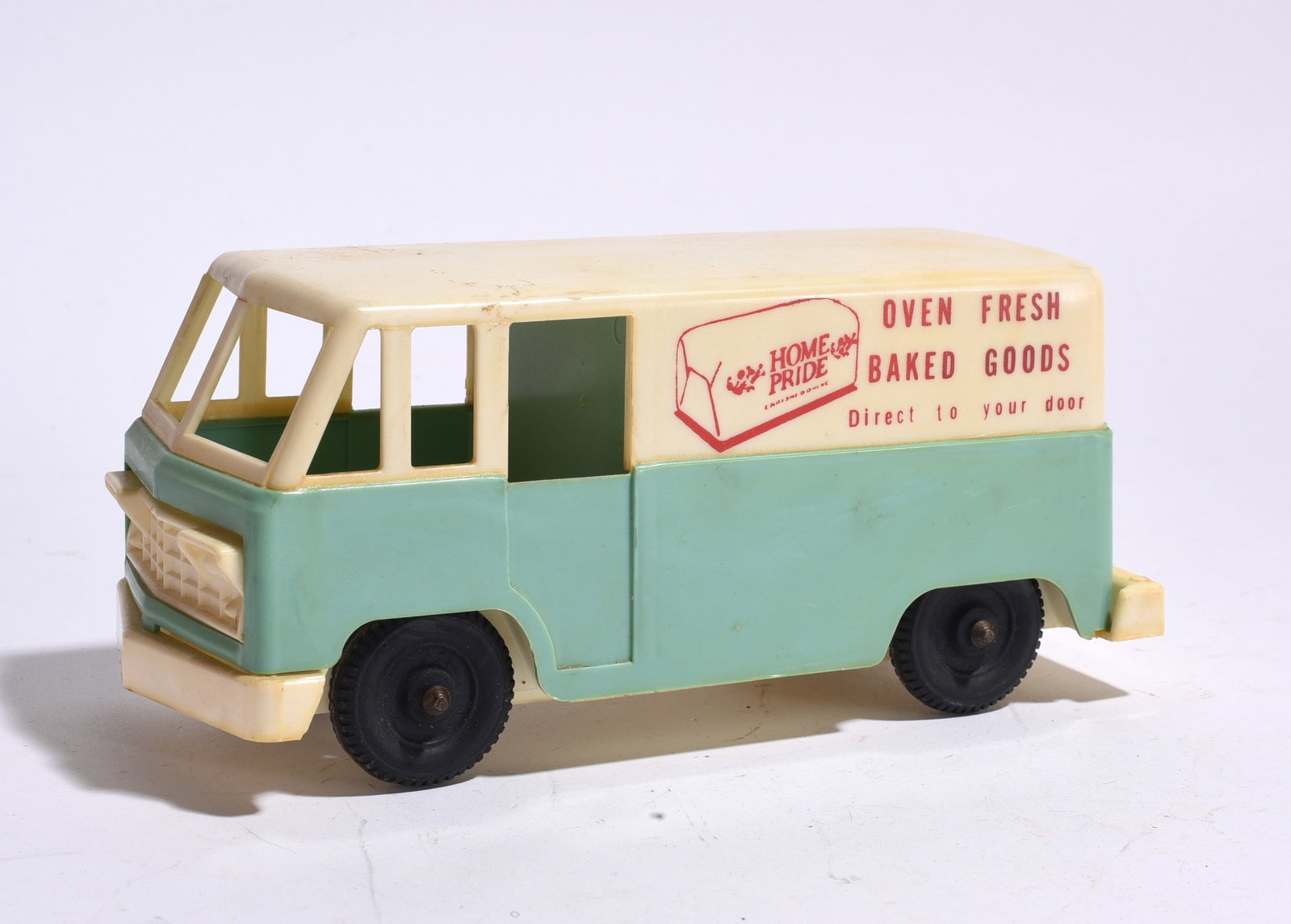 Home Pride Bakery Delivery Van: Home Pride bakery delivery van with "Oven Fresh Baked Goods" advertising graphics. Molded plastic construction with opening side door and light age-related wear.